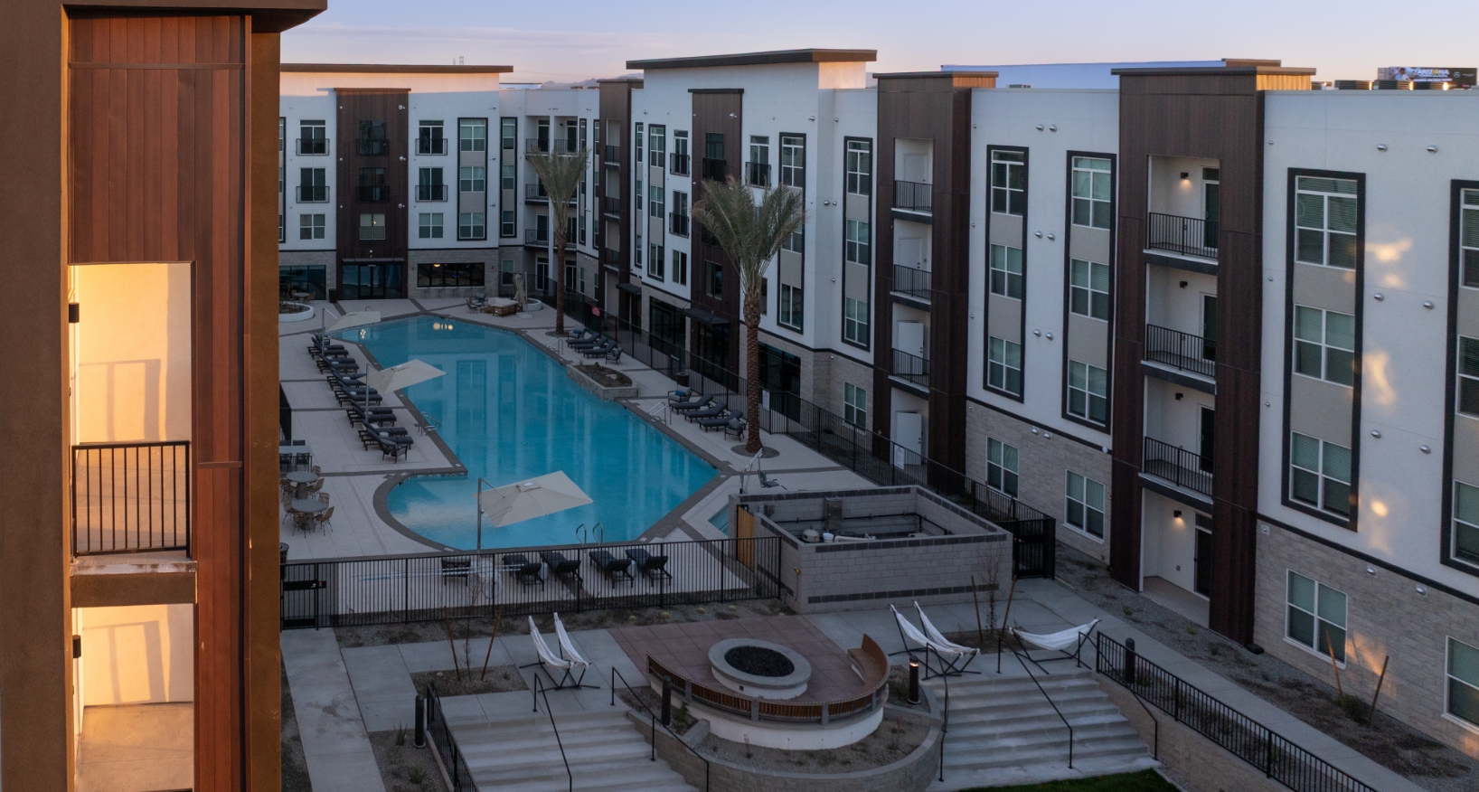Sunset aerial view of pool and fire pit