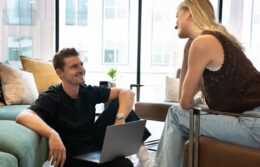 a man and woman having a conversation in the lobby